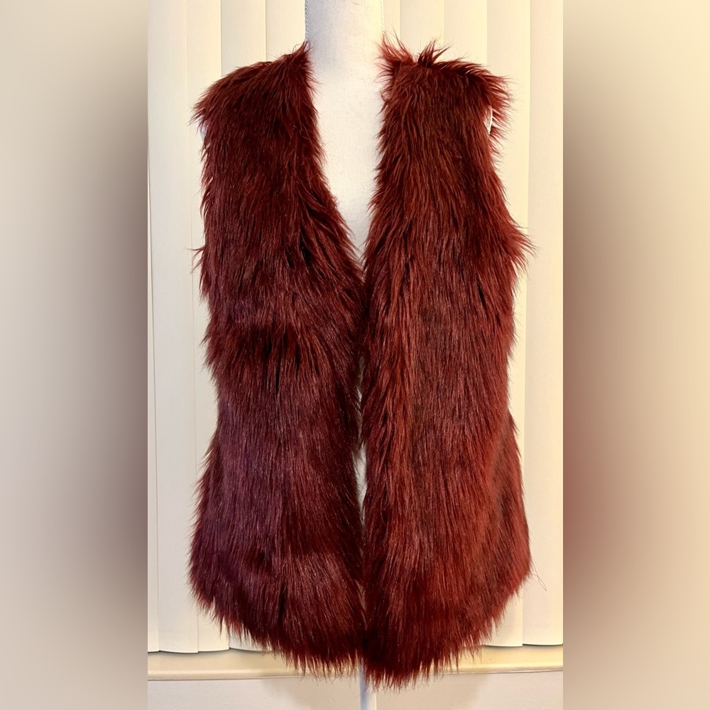 Faux fur vest by Gianni Bini. Clasp closure in front.-